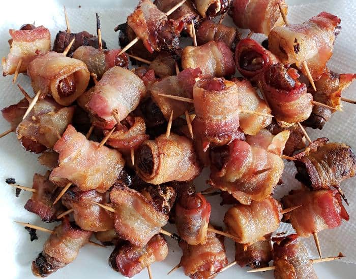 Image shows an overhead shot closeup of Bacon Wrapped Dates.