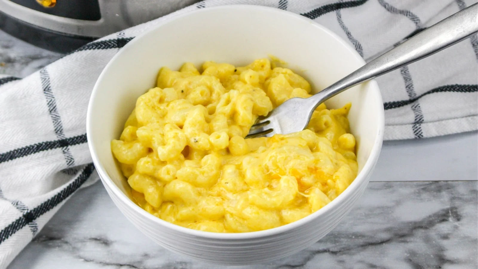 White bowl filled with slow cooker mac and cheese.