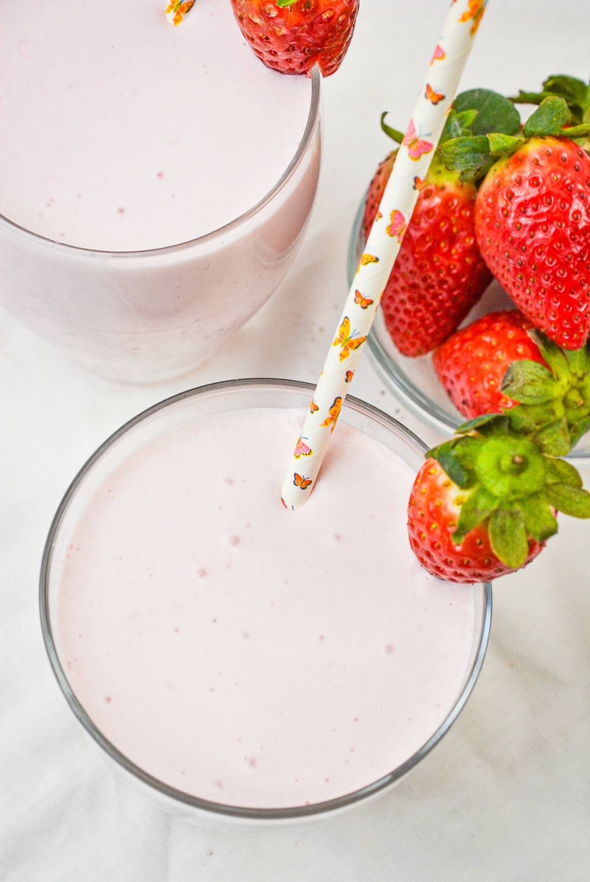 Overhead view of a smoothie made with strawberries and banana extract.