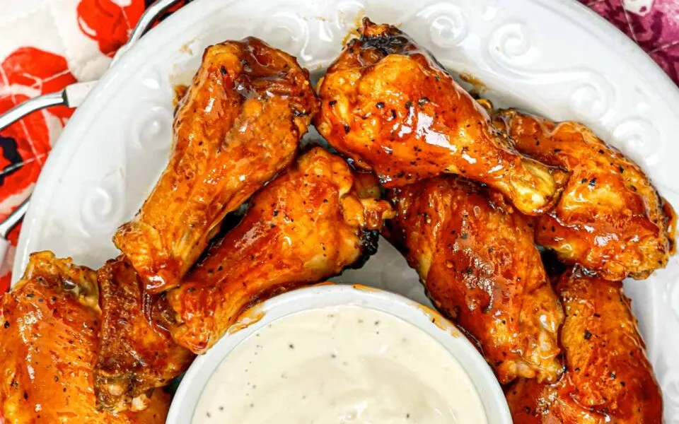BBQ Chicken wings on a white plate.