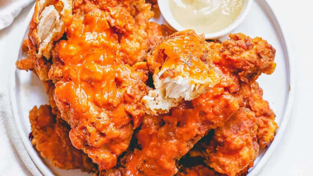 Buffalo chicken tenders on a white plate.