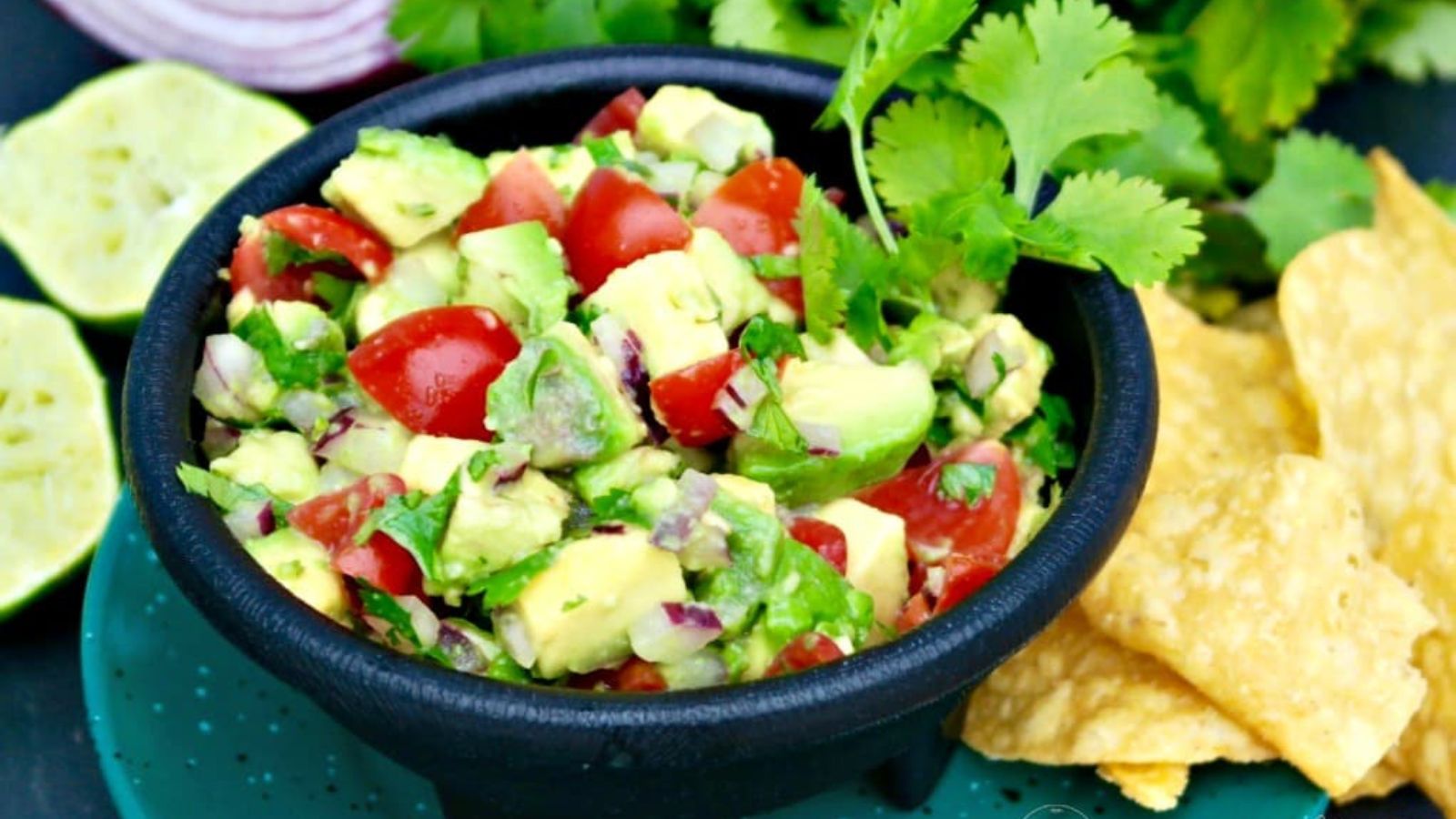 Bowl full of chunky avocado salsa and garnished with cilantro.
