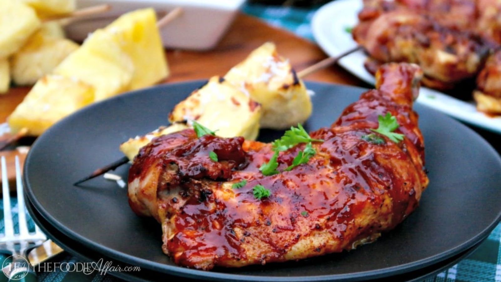 White platter of cooked bacon wrapped chicken thighs.