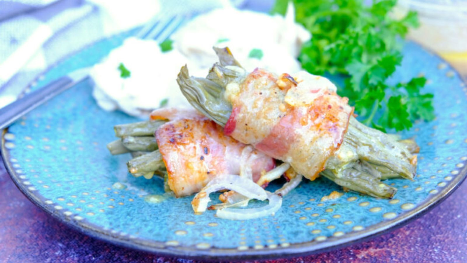 Bacon wrapped green bean bundles topped with a mustard vinaigrette.