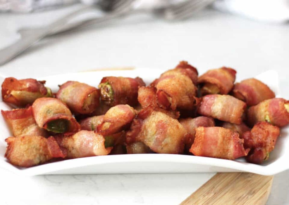 Bacon wrapped brussels sprouts on a serving platter. 
