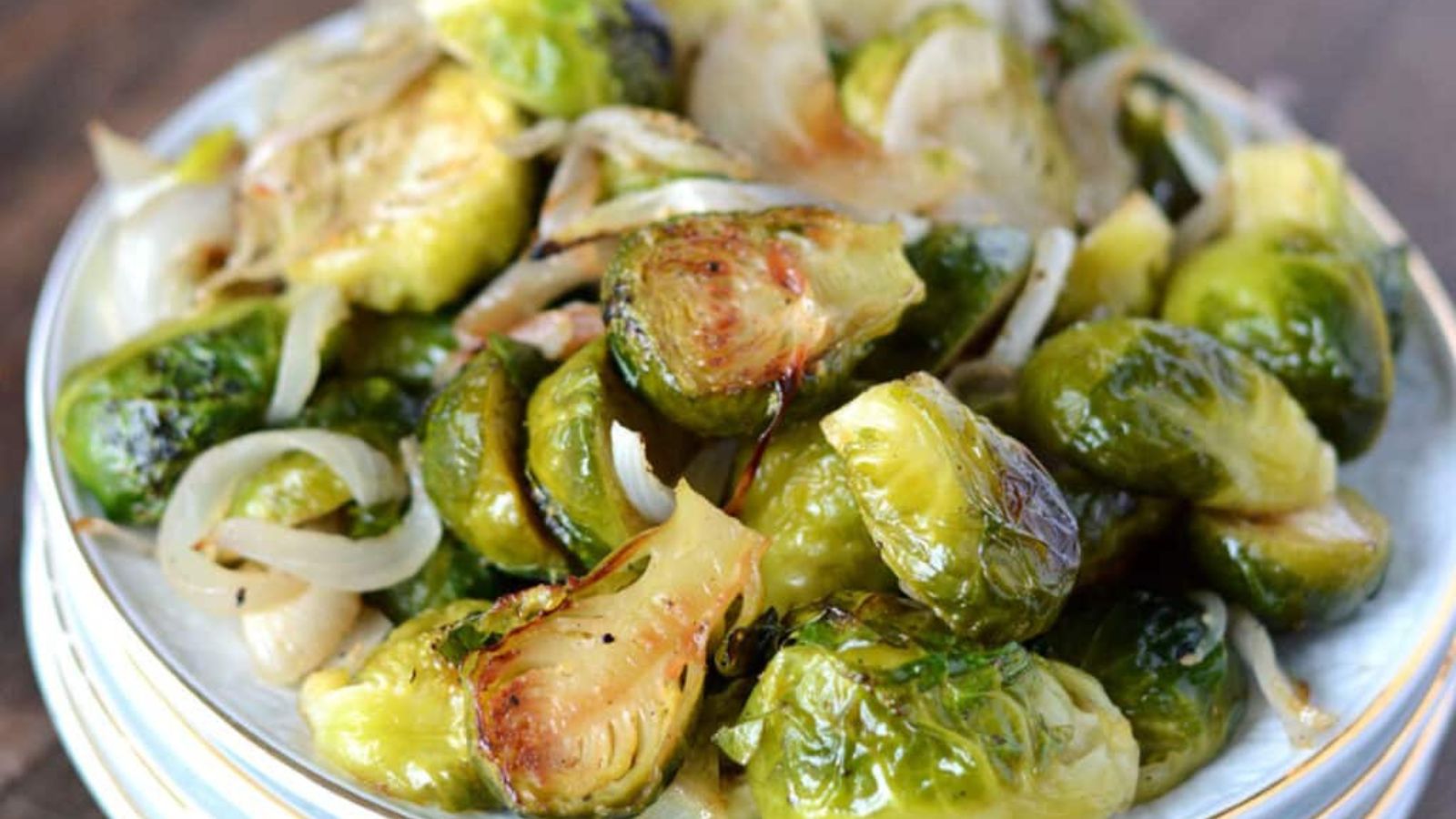 Brussels sprouts appetizer on a stack of small plates.