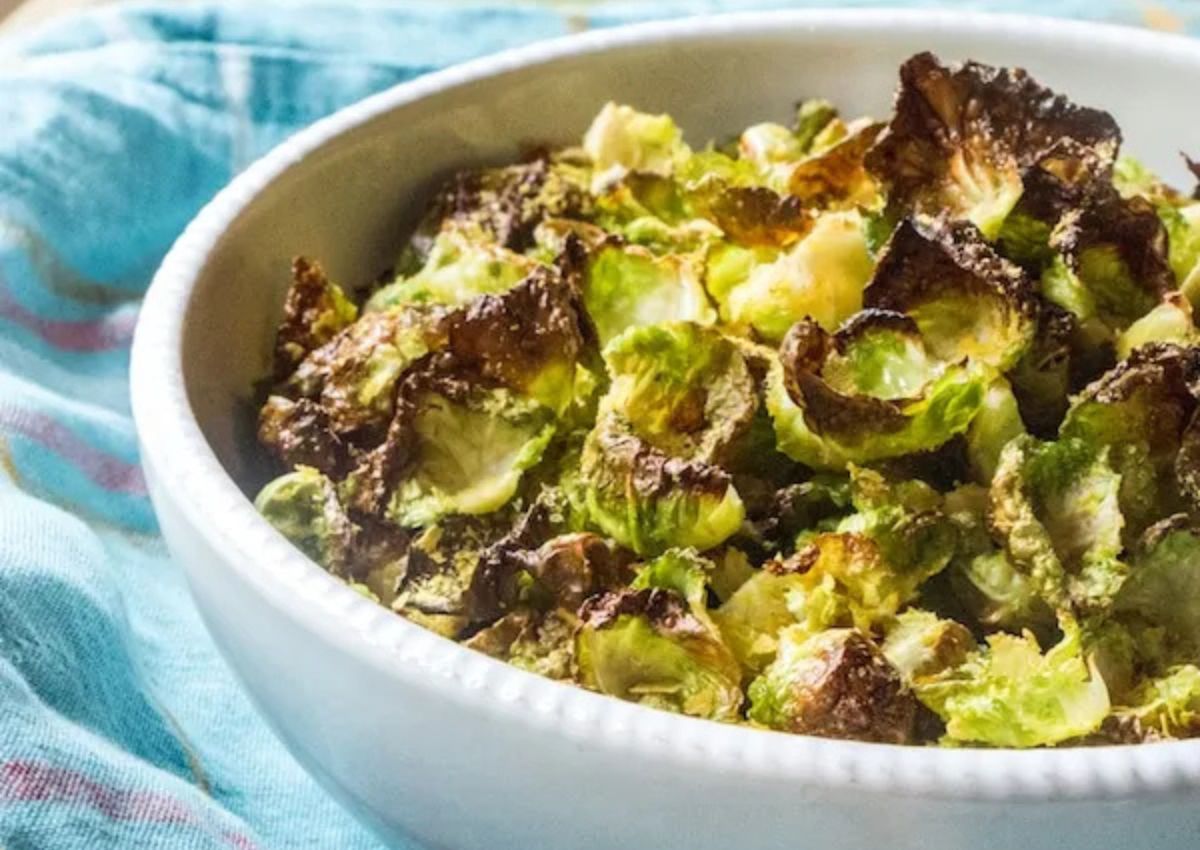 Serving of brussels sprouts chips in a white bowl. 