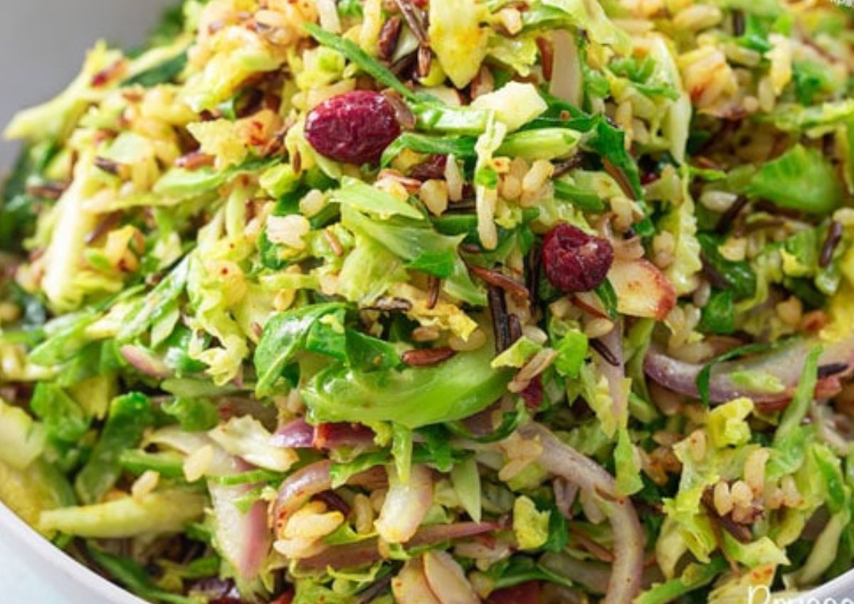 Serving of brussels sprouts pilaf in a white bowl. 