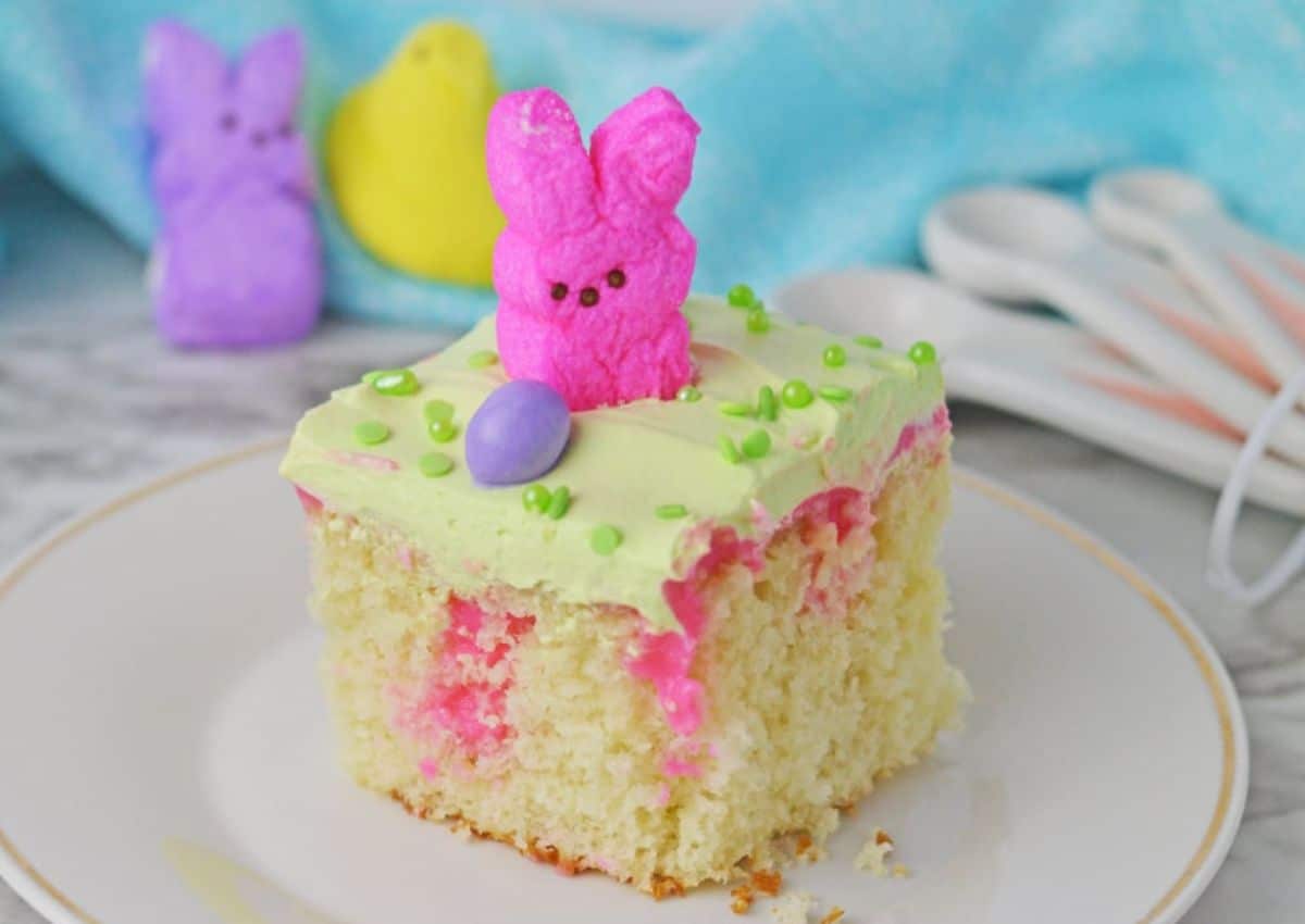 Slice of easter poke cake on a plate.