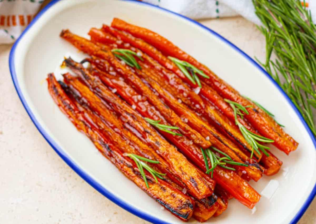Maple glazed carrots in a white baking dish.