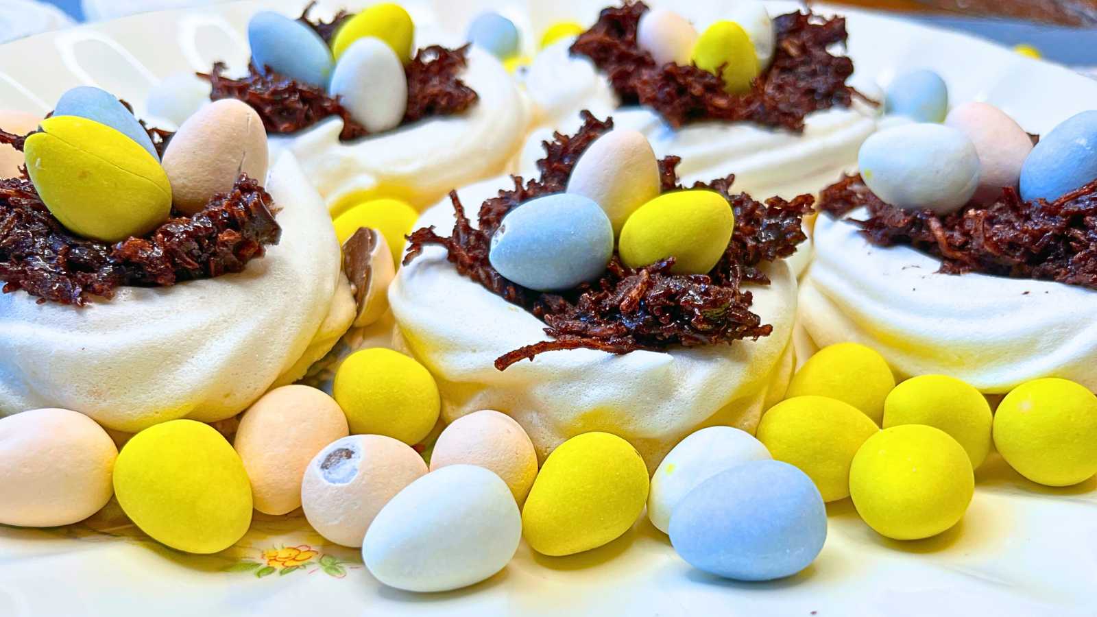 Easter nests with candy eggs around them.