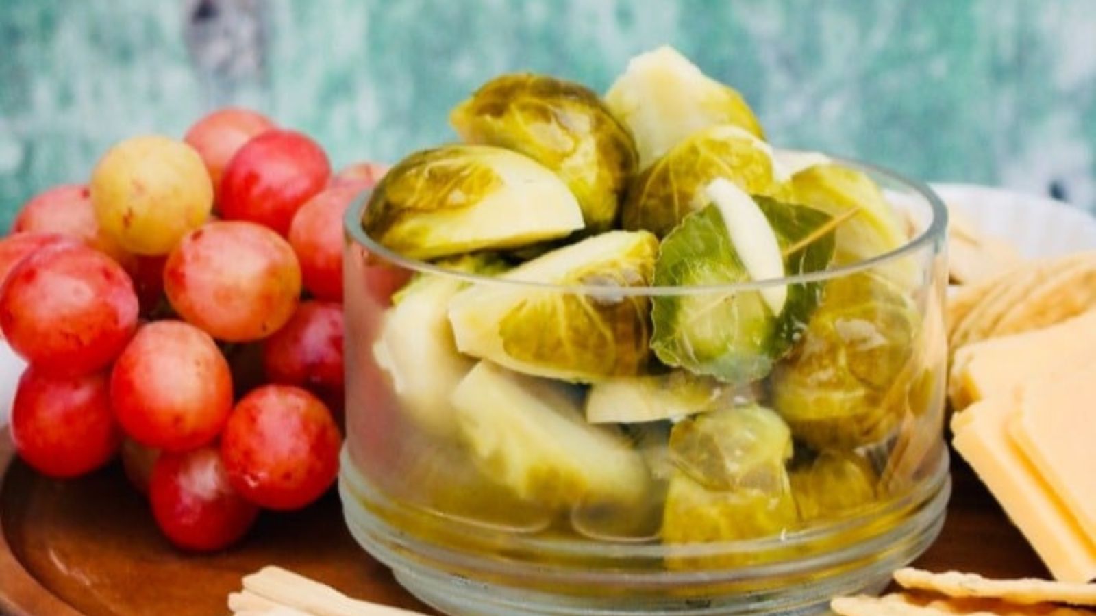 Pickled brussel sprouts in a small glass bowl. 