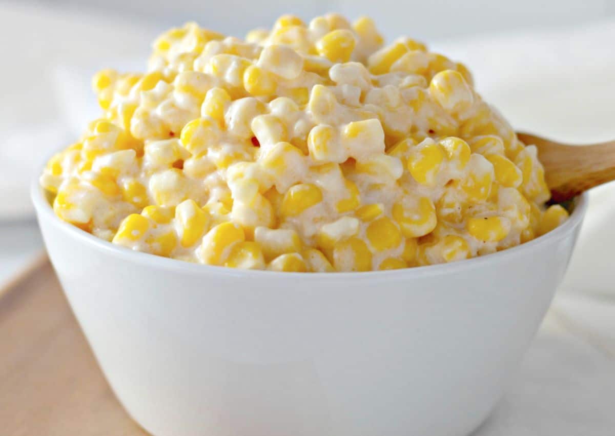 White bowl full of slow cooker creamy corn.