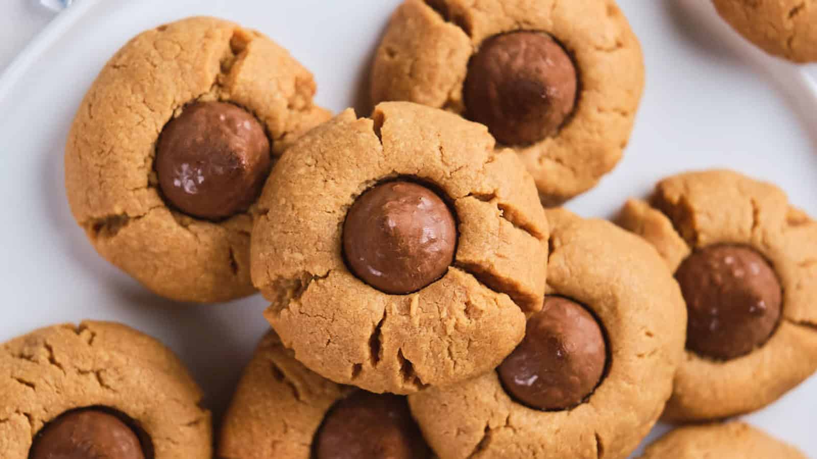 Peanut butter blossom cookies on a white plate.