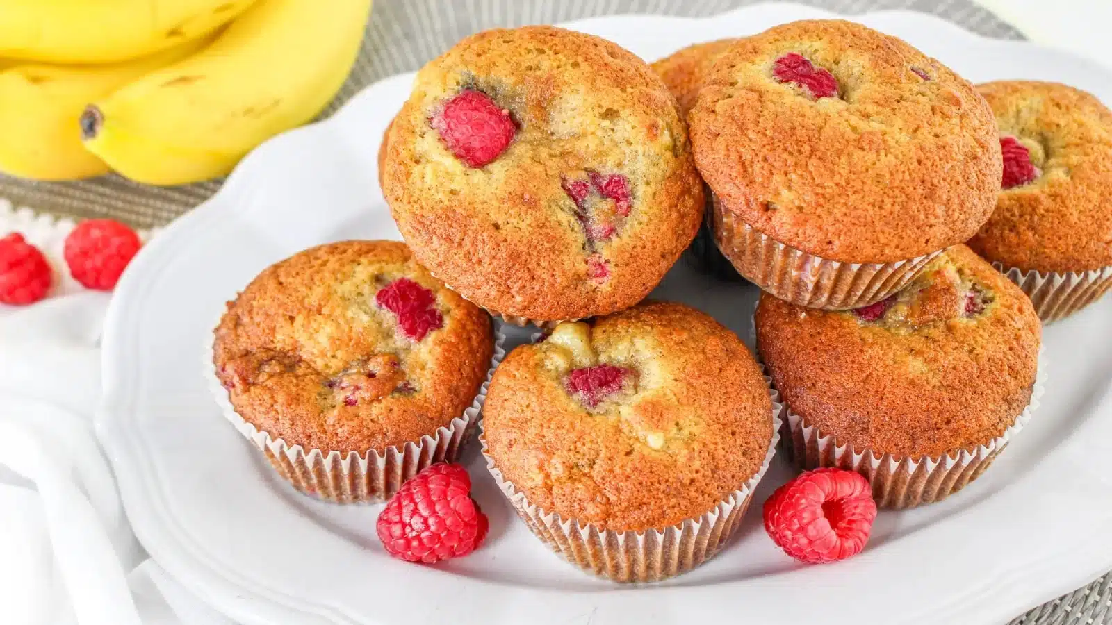 Banana raspberry muffins on a serving tray.