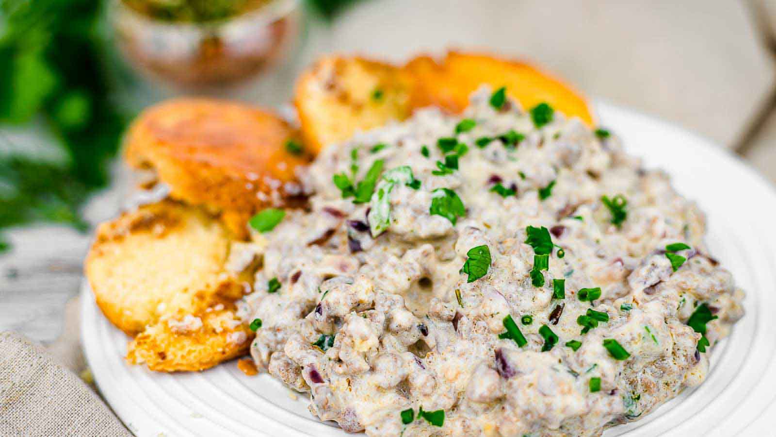 Keto biscuits and gravy on a white plate.