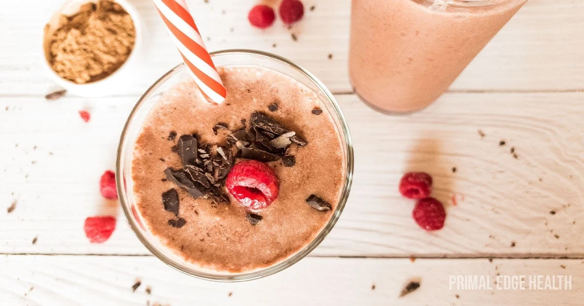 Overhead shot of a chocolate raspberry smoothie in a glass.