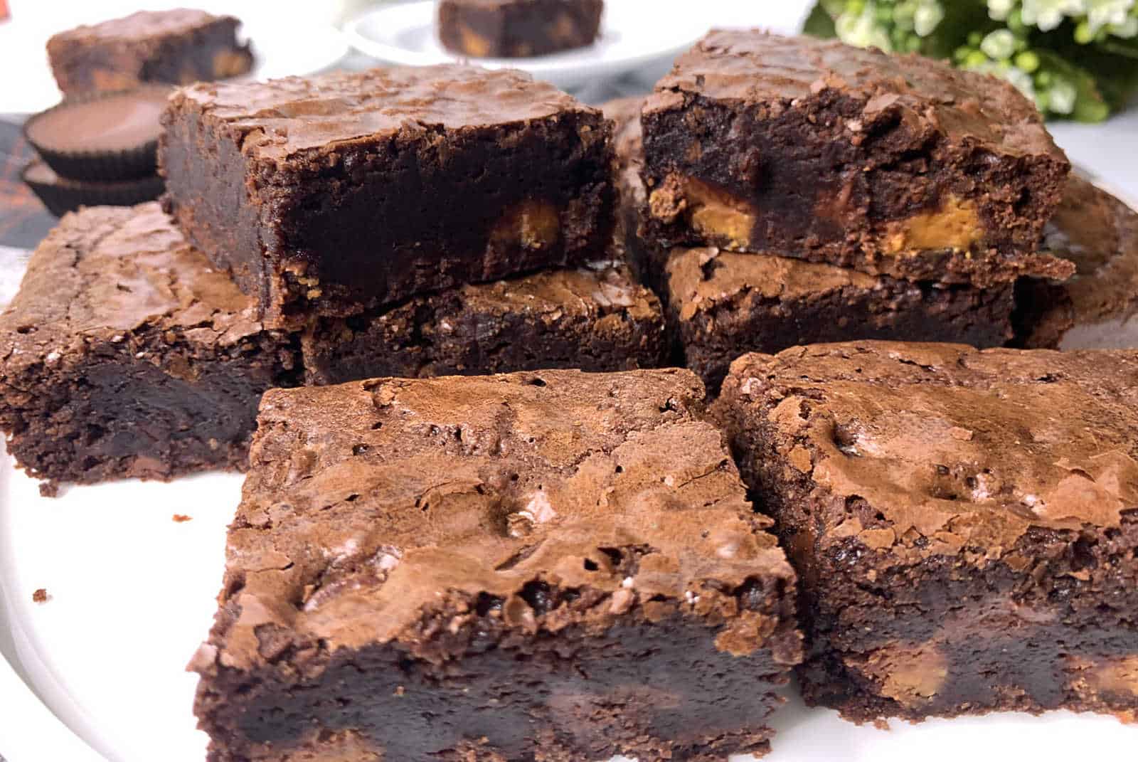 Brownies stacked on a plate.