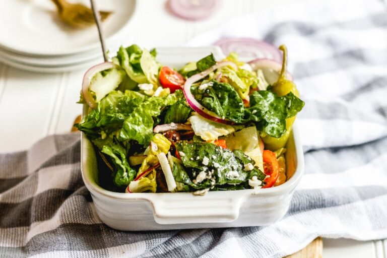 Small bowl of greek salad on a counter.