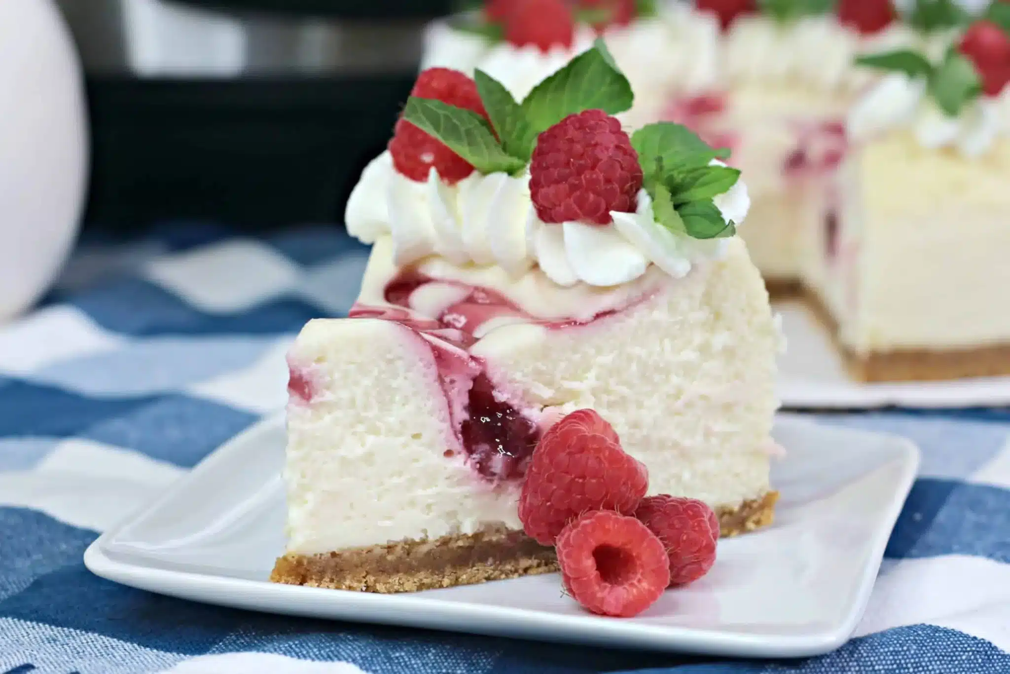 Slice of raspberry cheesecake on a small plate.