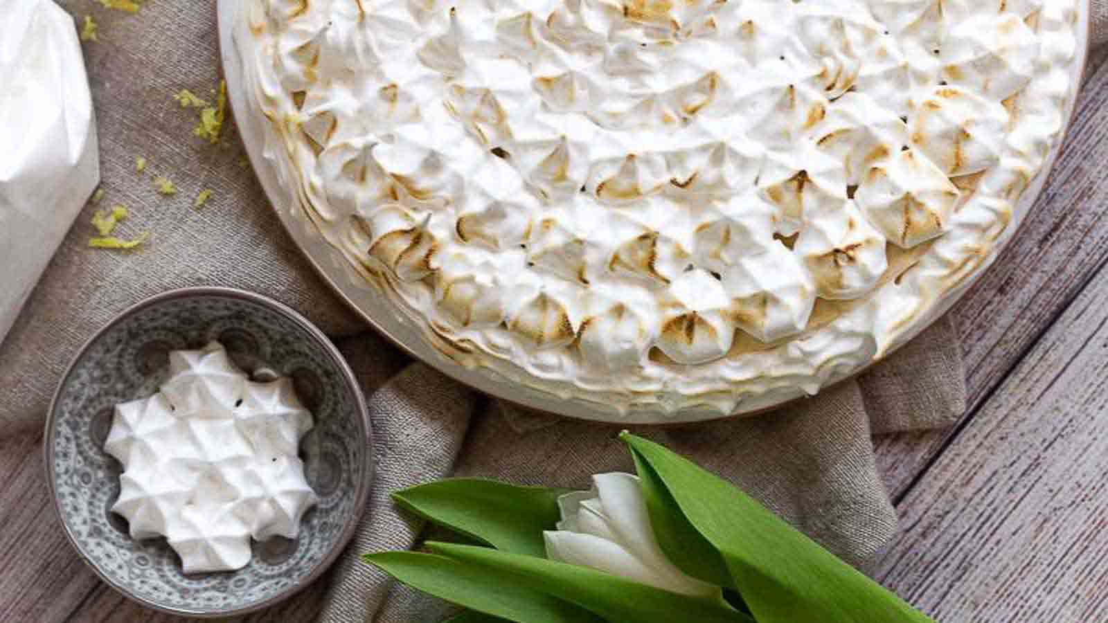 Pie plate full of lemon chesecake topped with merignue.