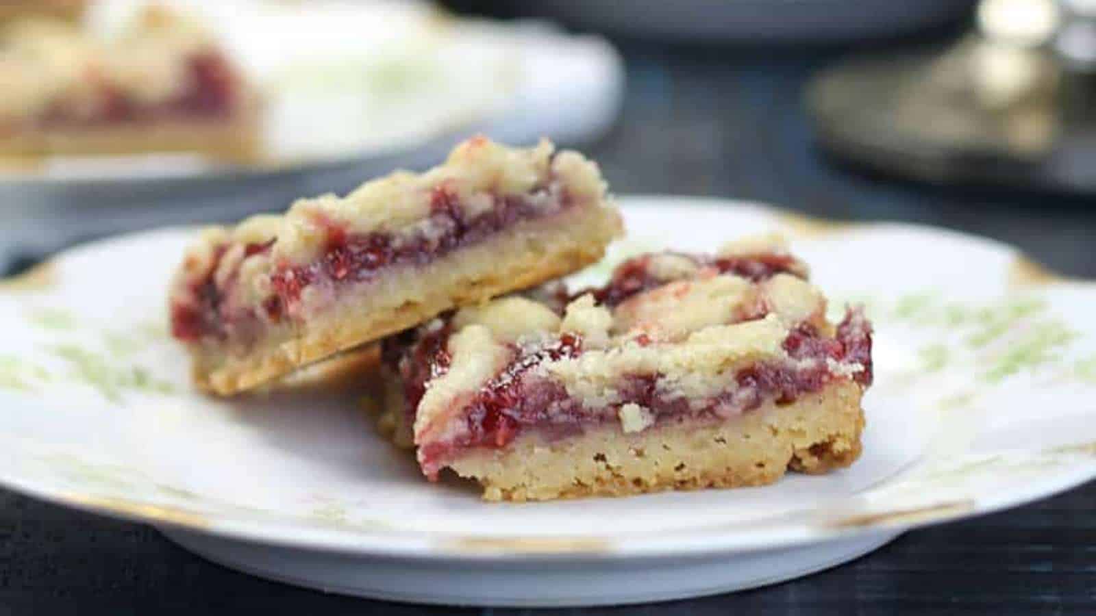 Two raspberry shortbread bars on a small plate.