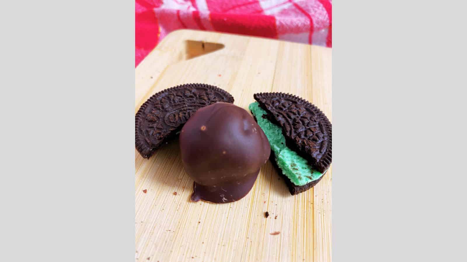 Mint truffles on a wooden cutting board.