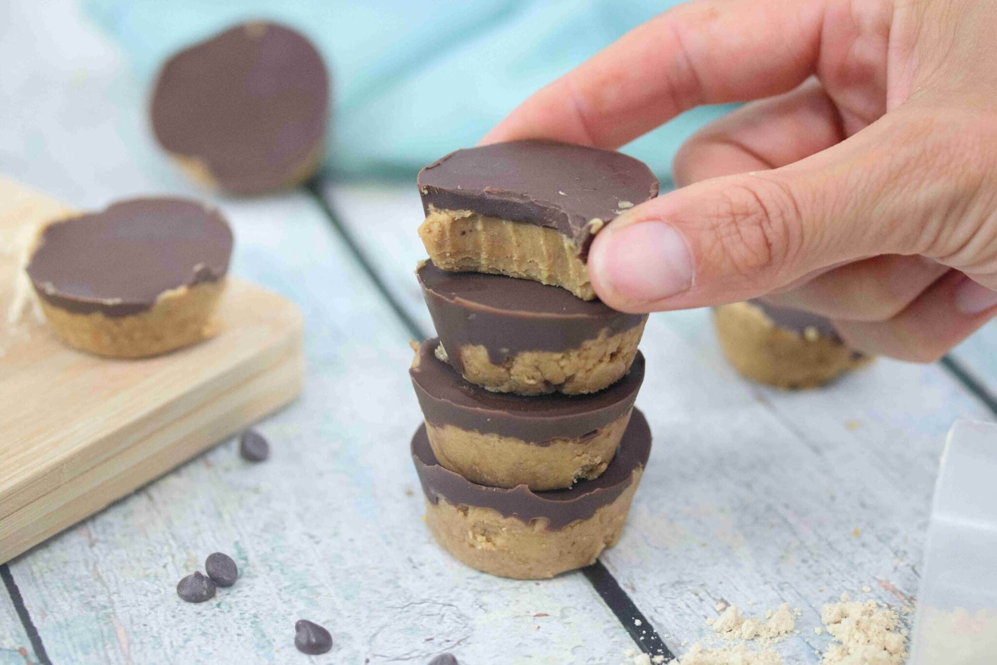 Four peanut butter protein cups on a cutting board.