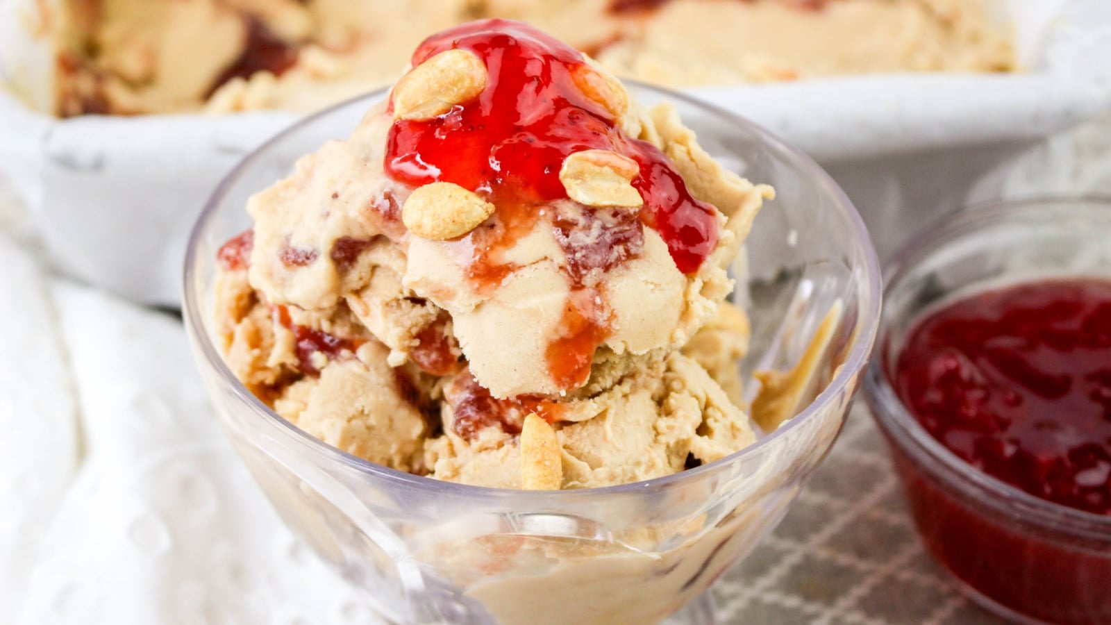 Peanut butter and jelly ice cream in a small glass bowl.