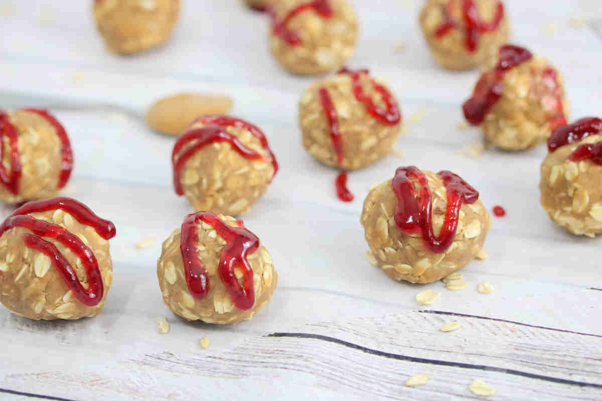 Peanut butter protein balls topepd with jam.