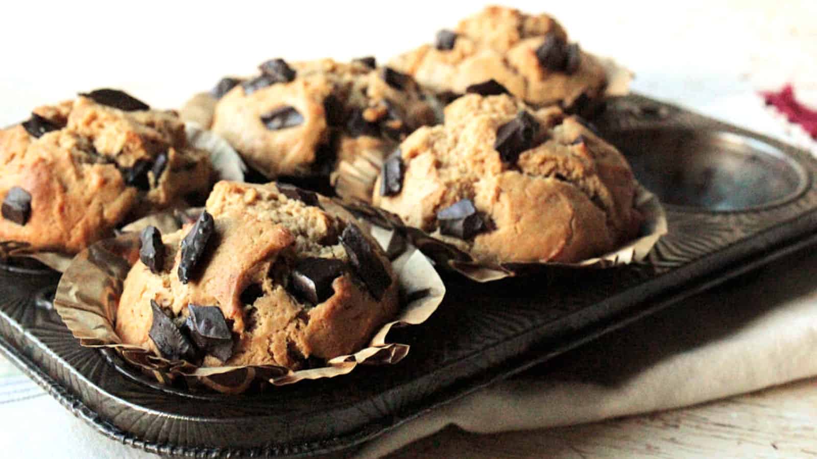 Peanut butter chocolate chip muffins in a muffin pan.