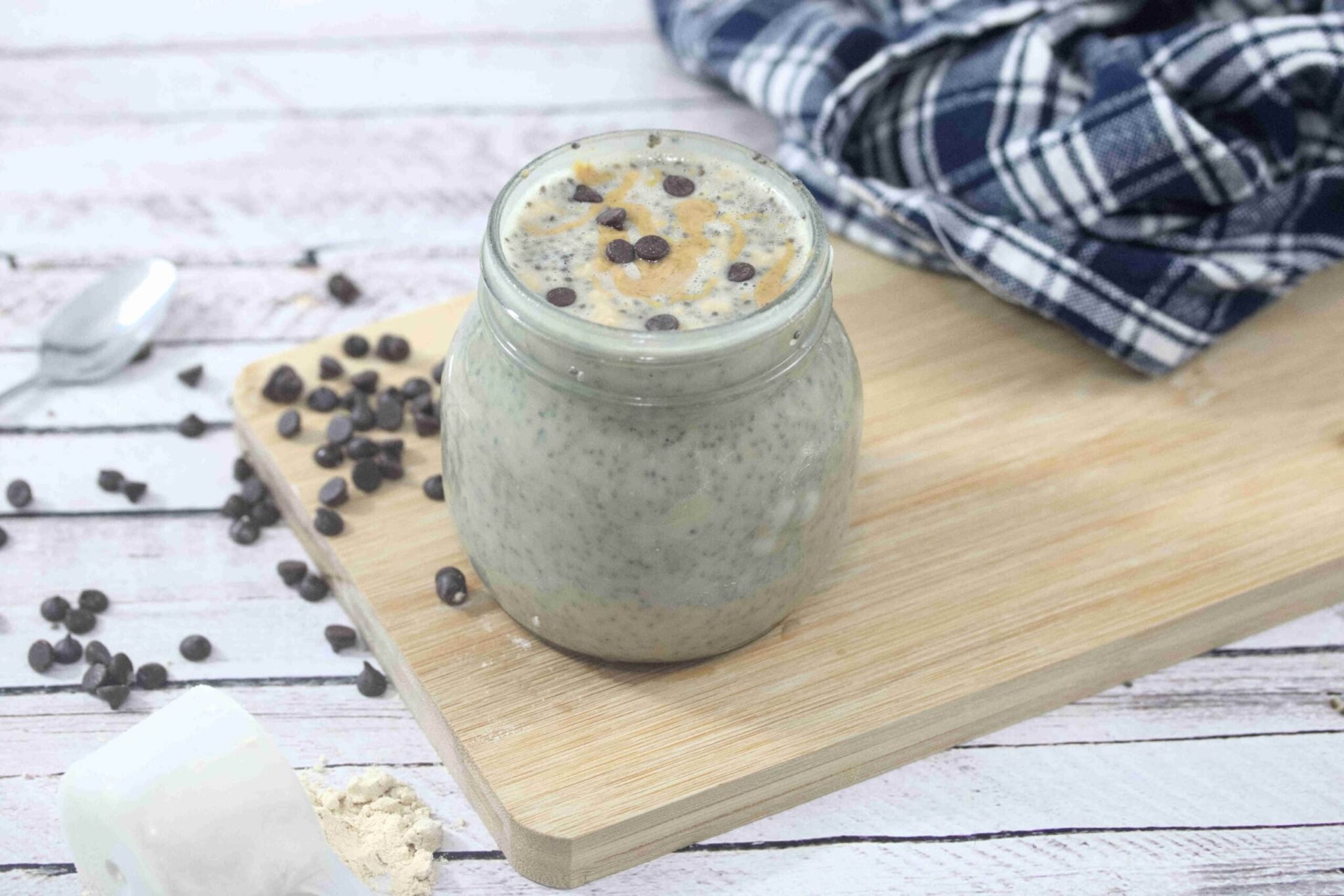 Peanut butter chia pudding on a wooden cutting board.