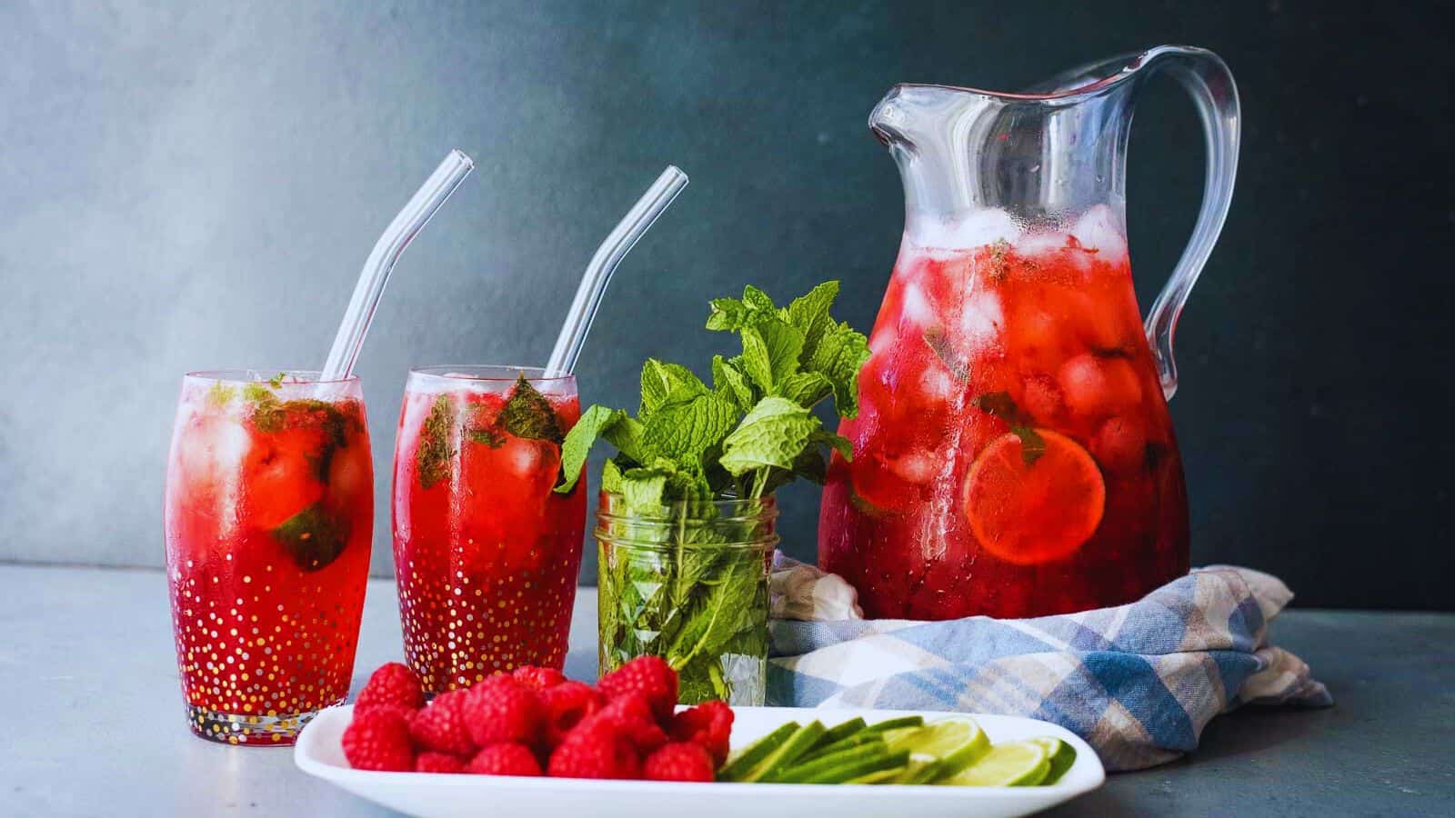 Raspberry mojito cocktail in a large pitcher.