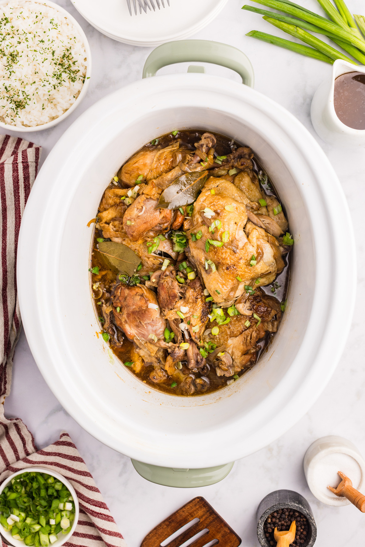 Top view of cooked chicken adobo in a slow cooker.