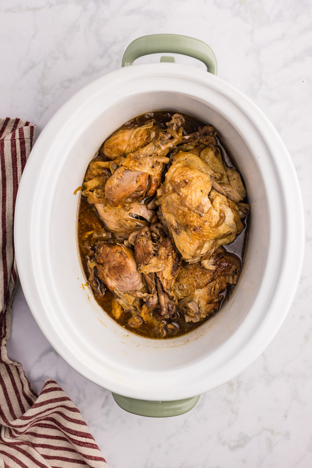 Top view of chicken in a slow cooker.