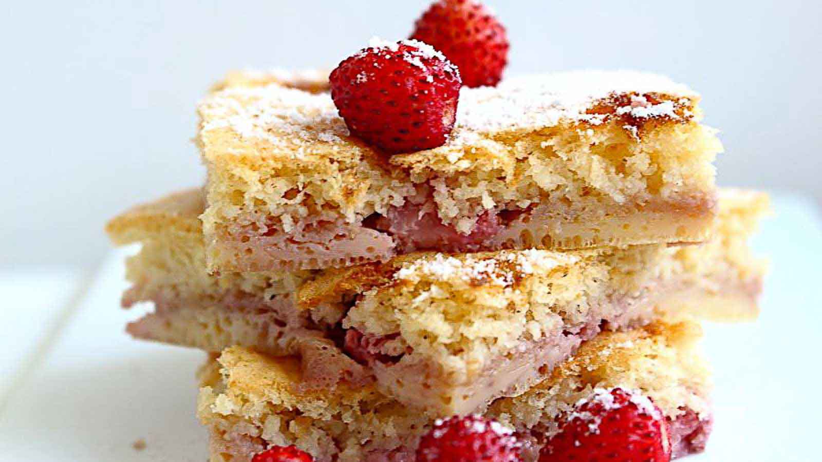 Three slices of strawberry coffee cake stacked on top of each other.