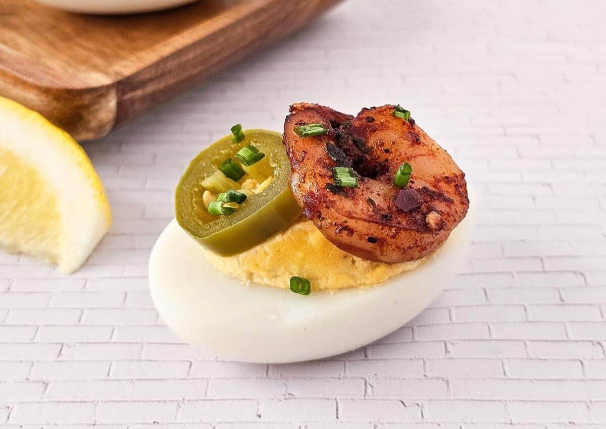 Shrimp deviled egg on a brick background.