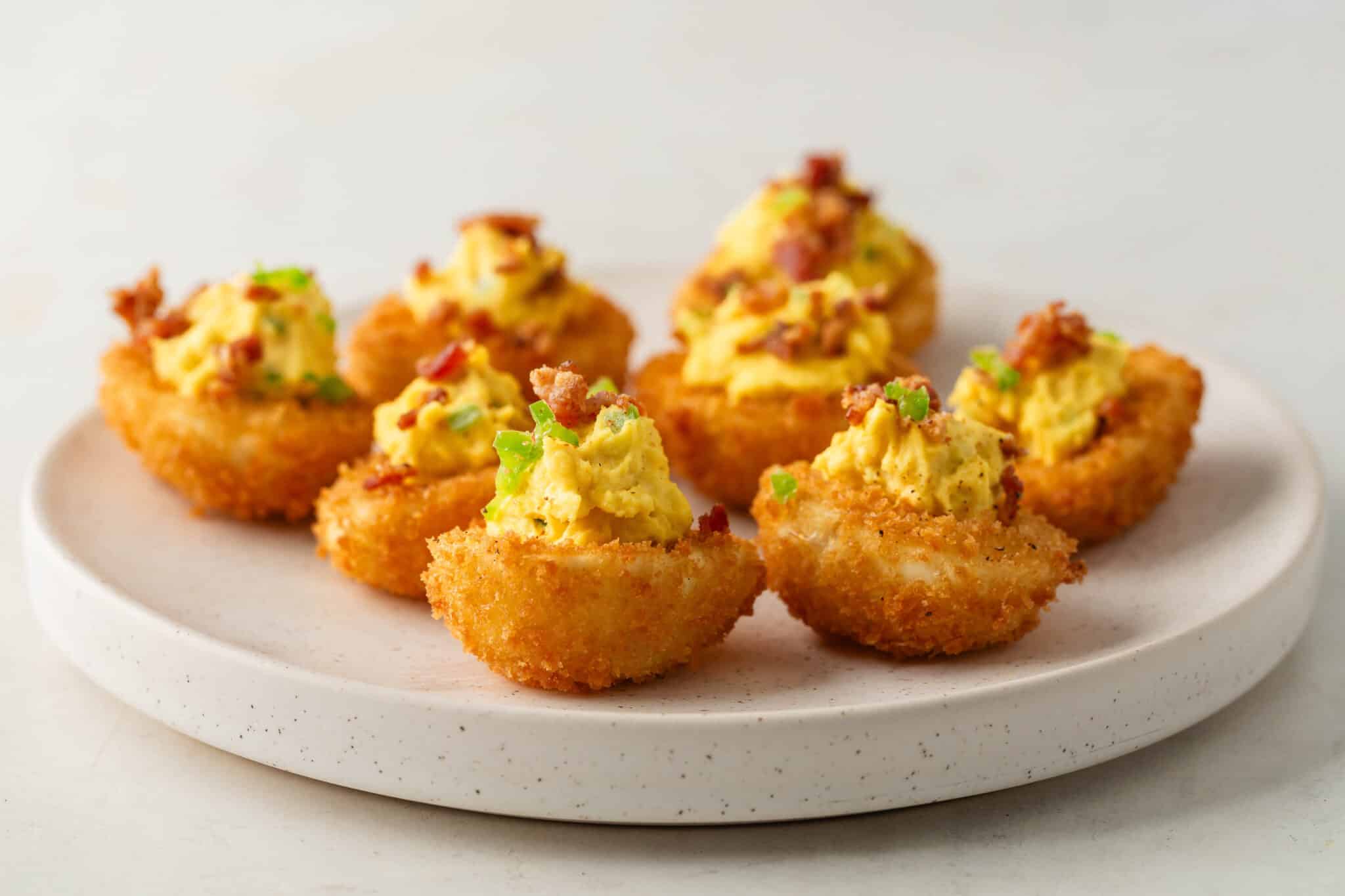 Deep fried deviled eggs on a platter.