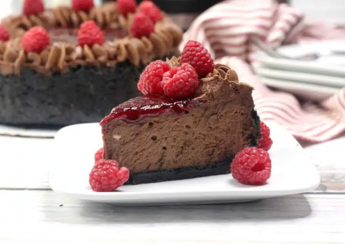 Slice of chocolate raspberry cheesecake on a small plate.