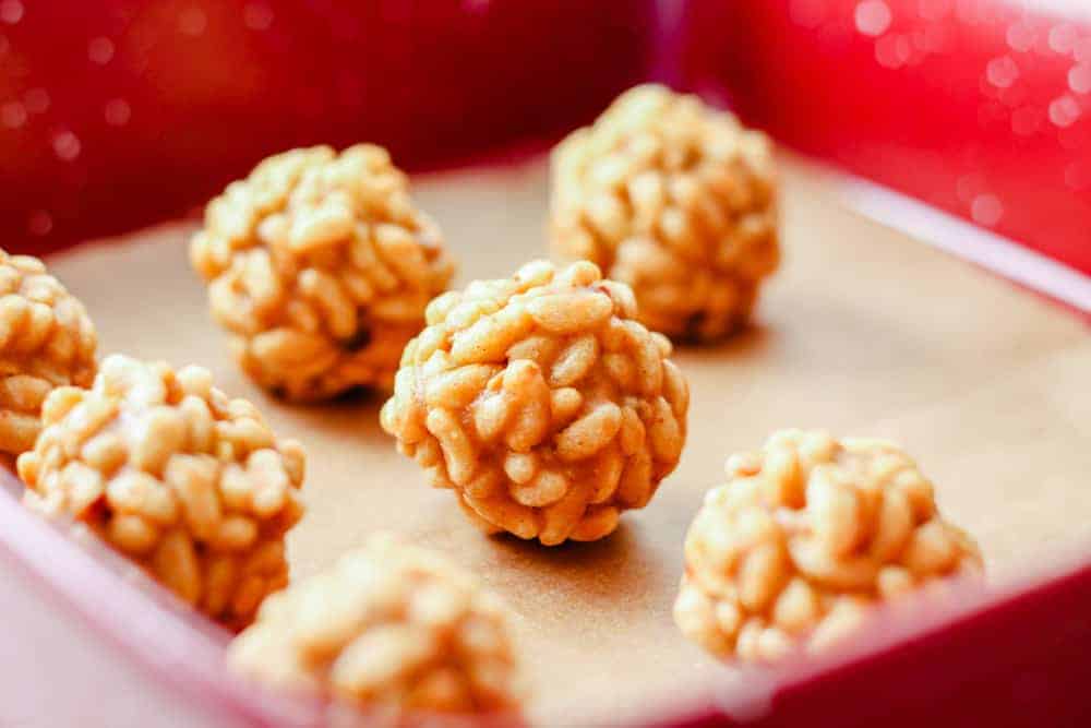 Peanut butter rice krispies treat balls in a baking dish.