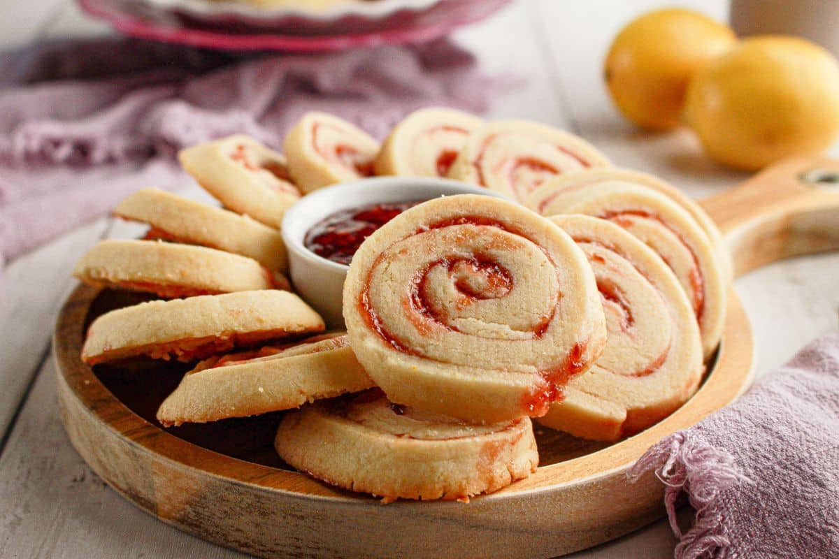 Raspberry lemon cookies on a wooden serving tray.
