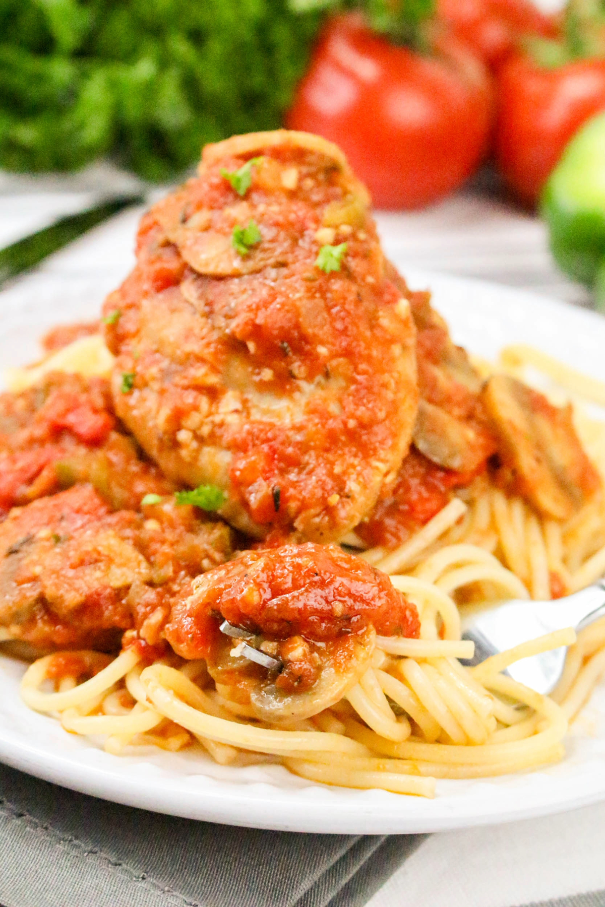 Chicken thighs with a rich tomato wine sauce over noodles.