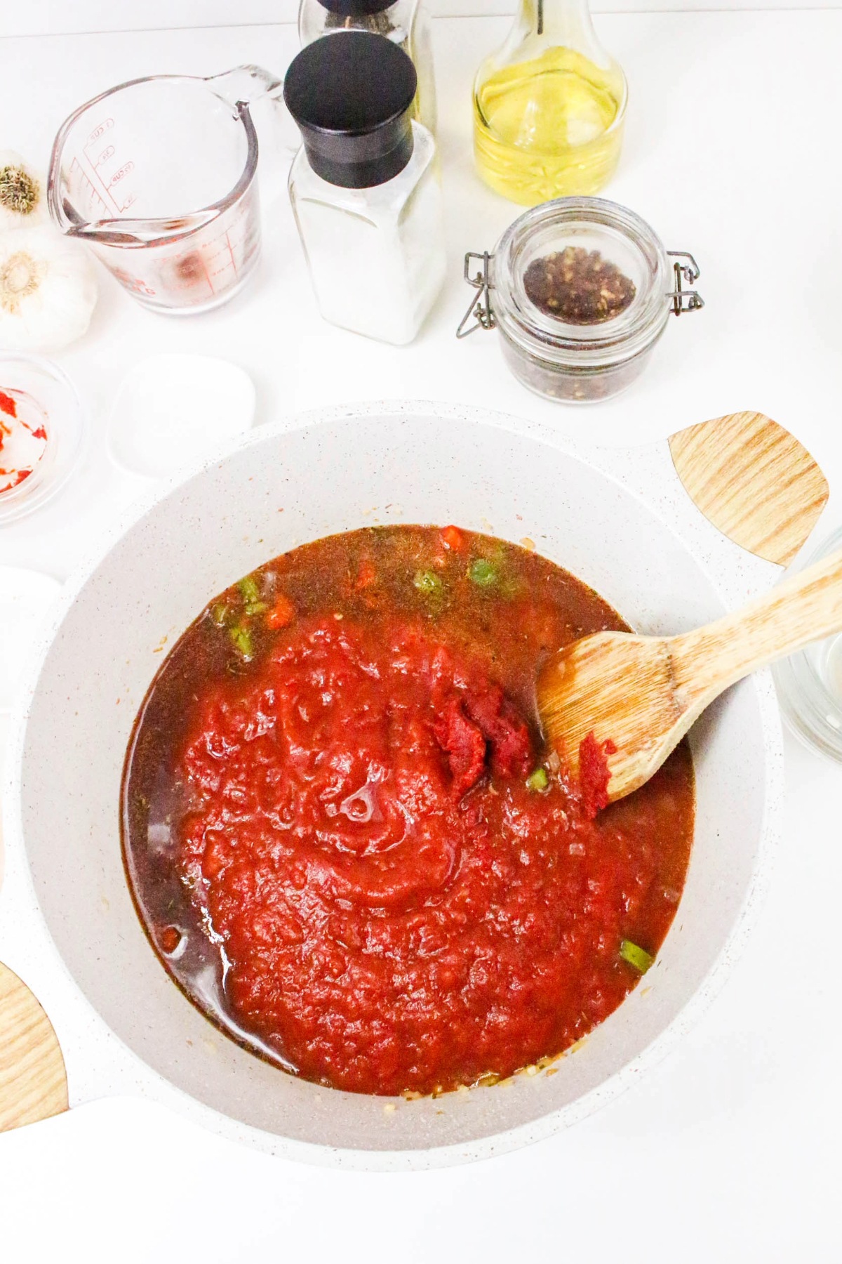 tomato and wine based sauce mix in a white stock pot.