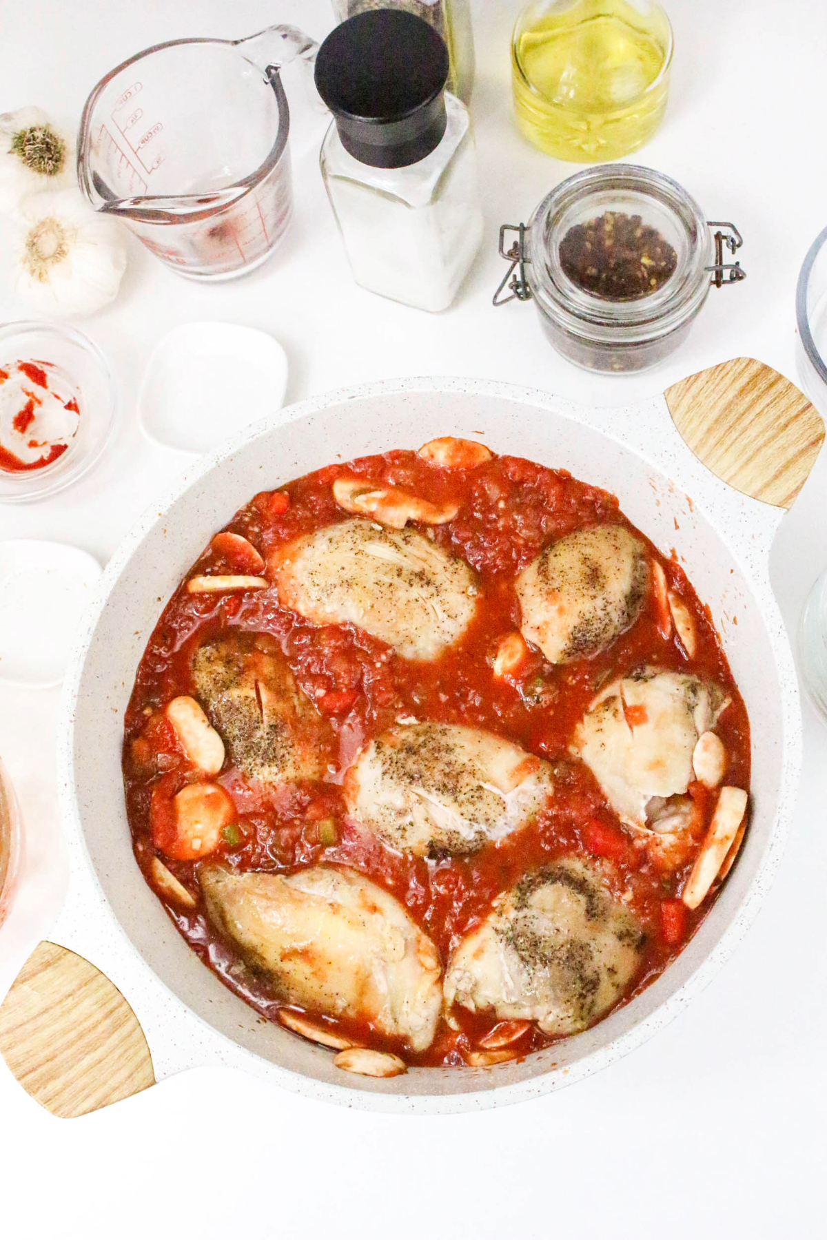 Overhead view of chicken cacciatore in a dutch oven.