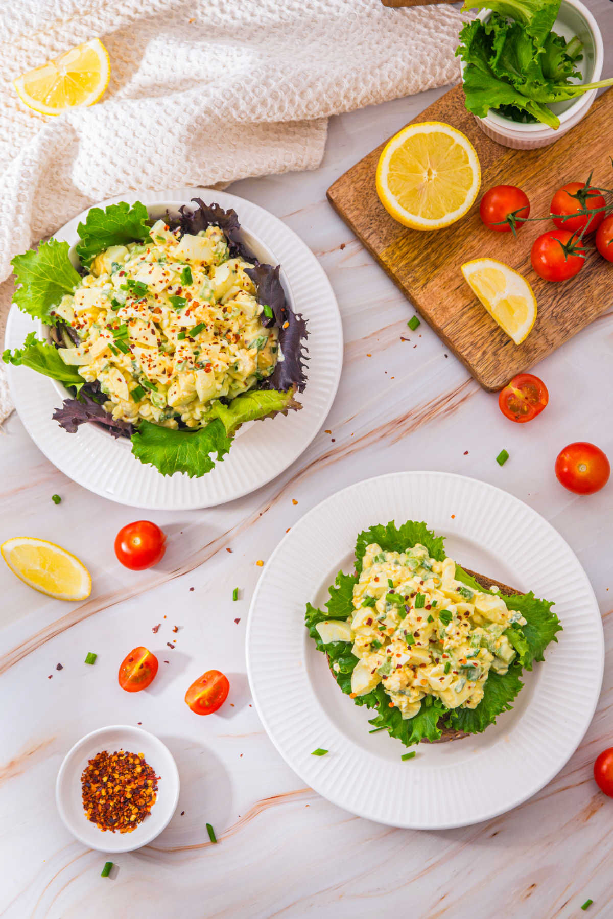 Top view of egg salad on a slice of bread and in a bowl.