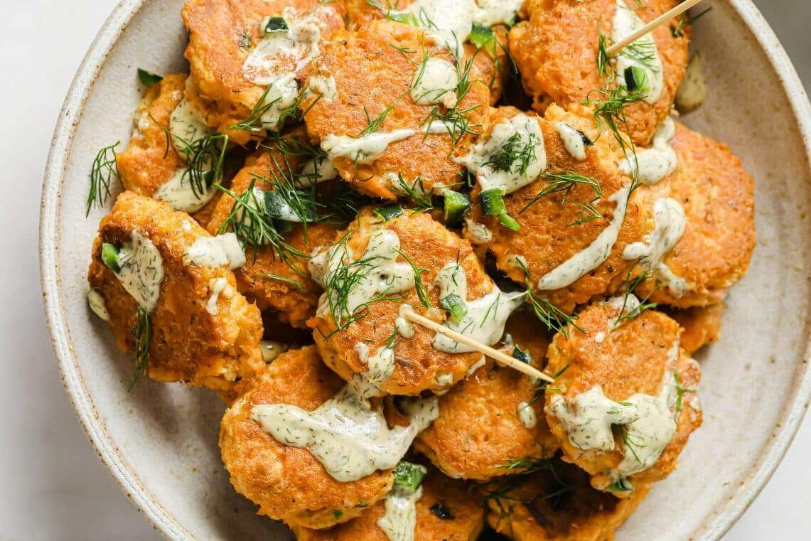 Mini salmon patties on a plate.