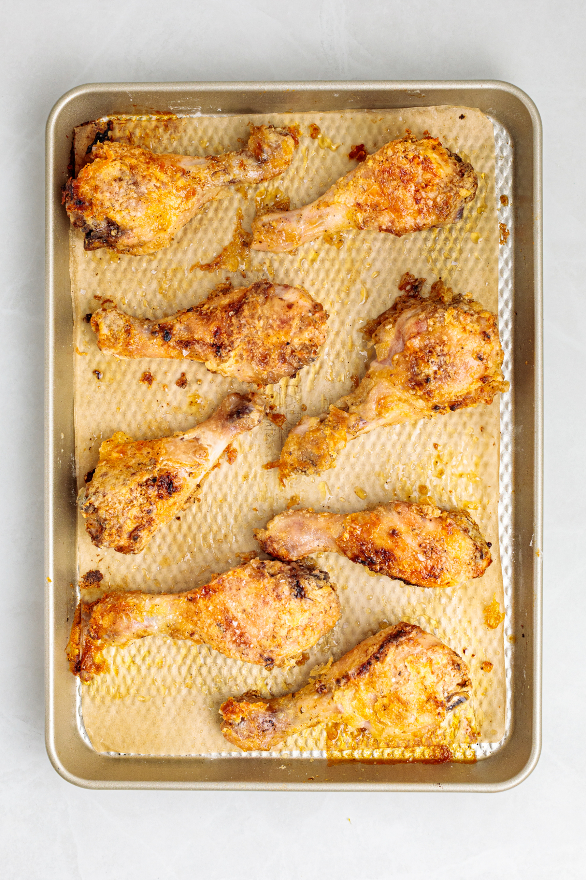 Cooked drumsticks on a baking sheet.