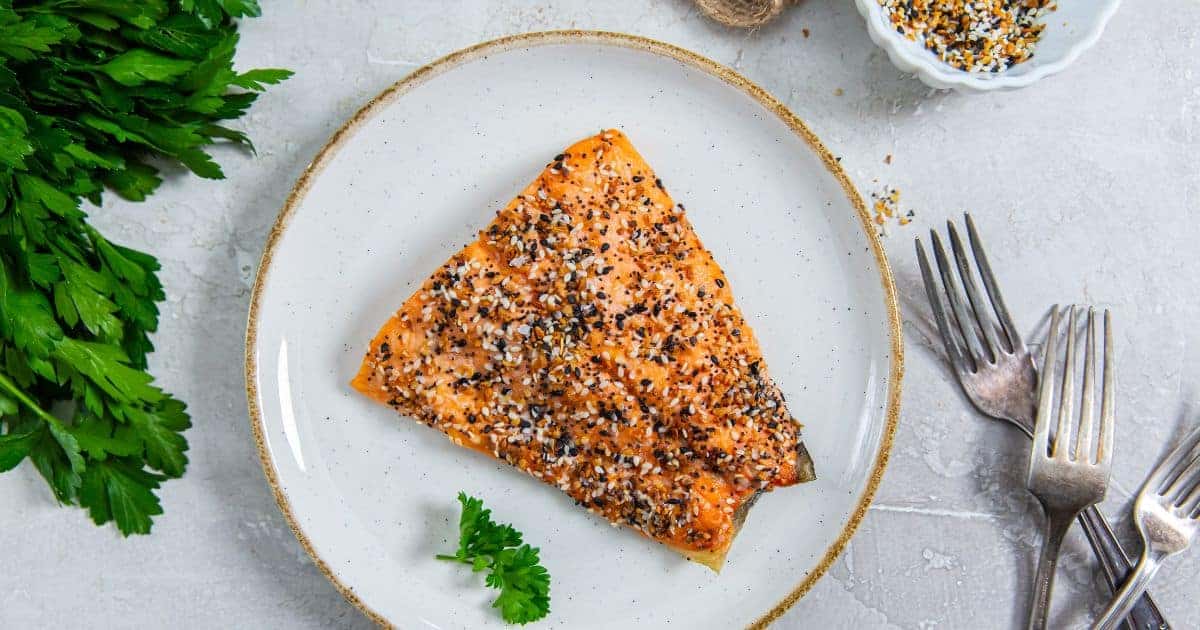 Everything bagel seasoned salmon on a plate.