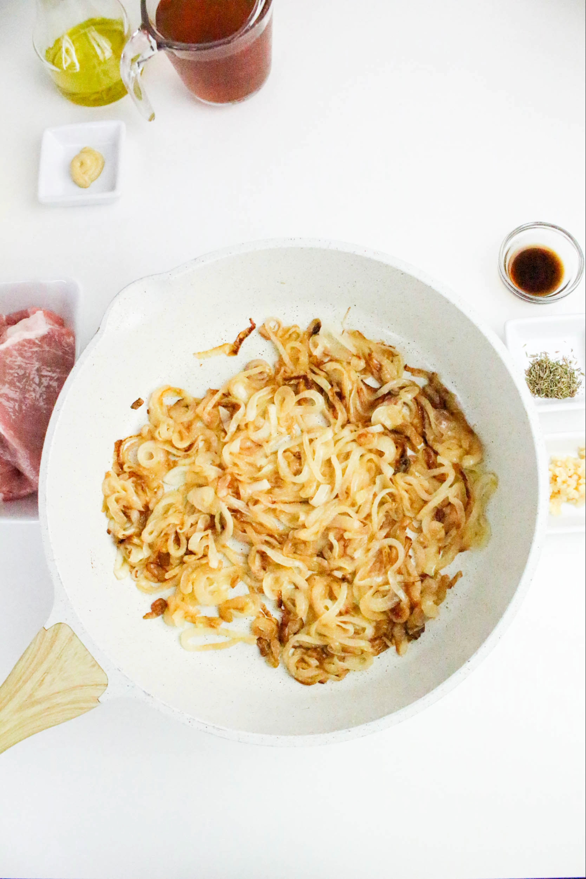 Sliced onions in a skillet cooking to caramelize.