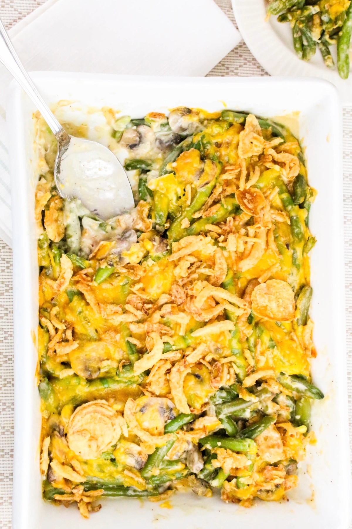 Overhead view of fresh green bean casserole in a white baking dish.